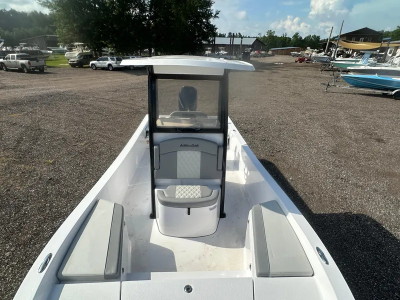 Slide: The Image of 2026 Action Craft 24 Bay boat with seating, parked in a gravel lot. - 30