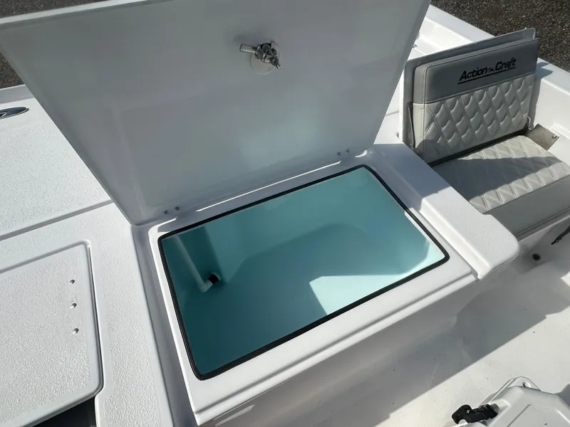 Slide: The Image of 2026 Action Craft 24 Bay boat with open storage compartment and cushioned seating. - 32