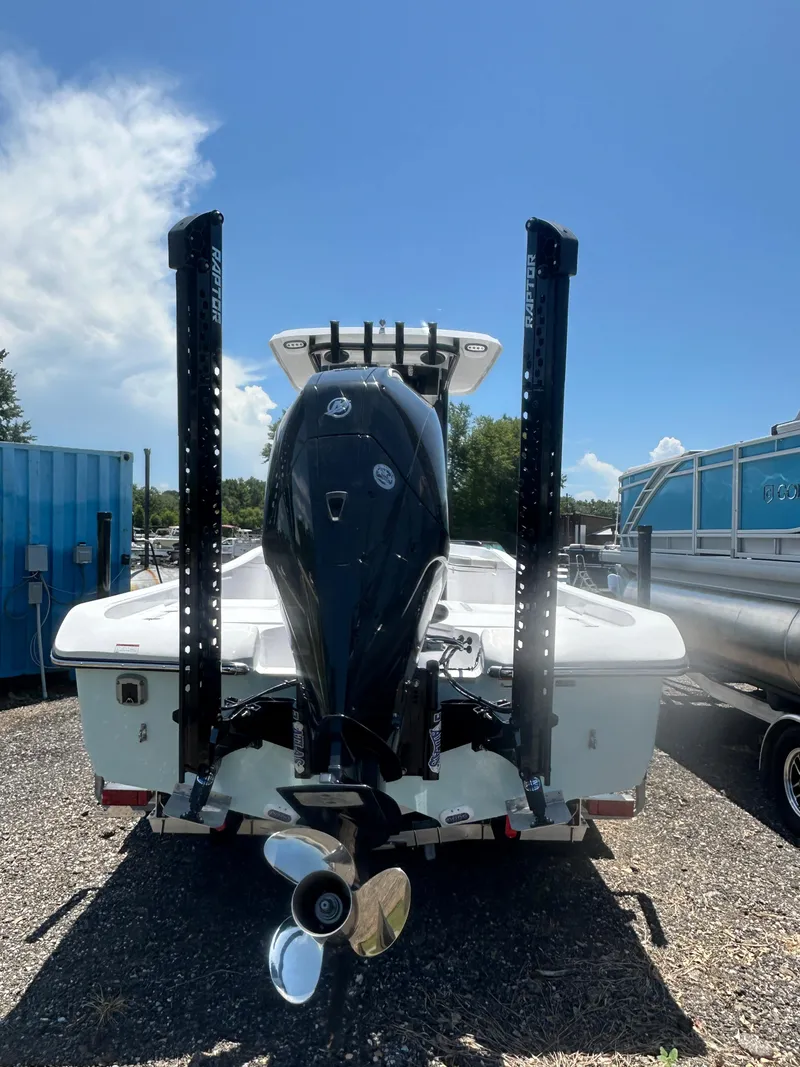 Slide: The Image of 2026 Action Craft 24 Bay boat with powerful outboard motor, parked outdoors. - 8