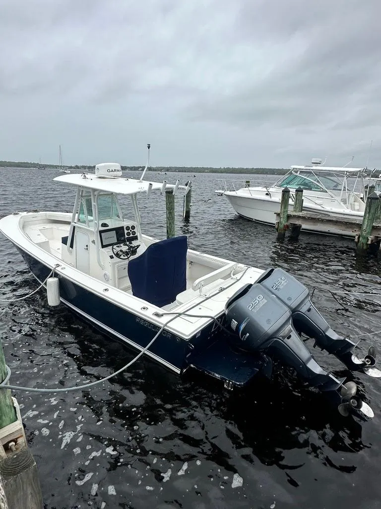 The Image of 2005 Regulator 26 Forward Seating boat docked on a cloudy day. - 0