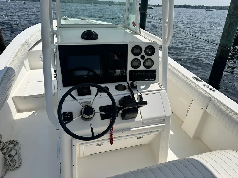 Slide: The Image of 2005 Regulator 26 Forward Seating boat cockpit with steering wheel and control panel. - 4