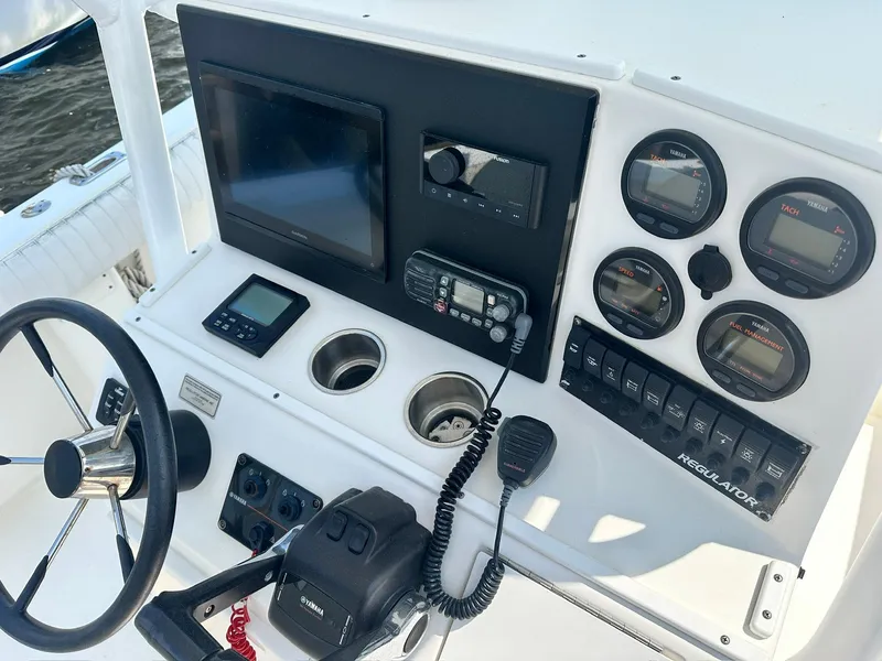 Slide: The Image of Control panel of a 2005 Regulator 26 Forward Seating boat with gauges and electronics. - 5