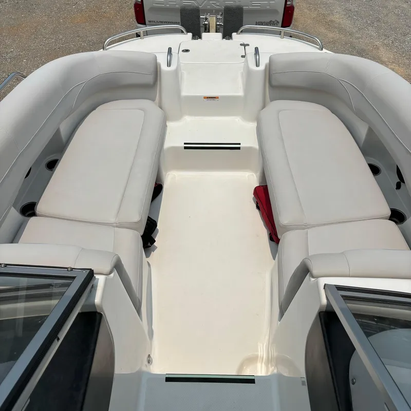 Slide: The Image of 2020 Splendor Odyssey 220 boat interior with white seating and open deck layout. - 10