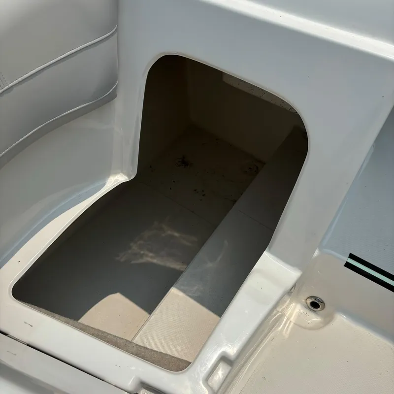 Slide: The Image of Storage compartment on a 2020 Splendor Odyssey 220 boat, featuring clean white interior. - 12