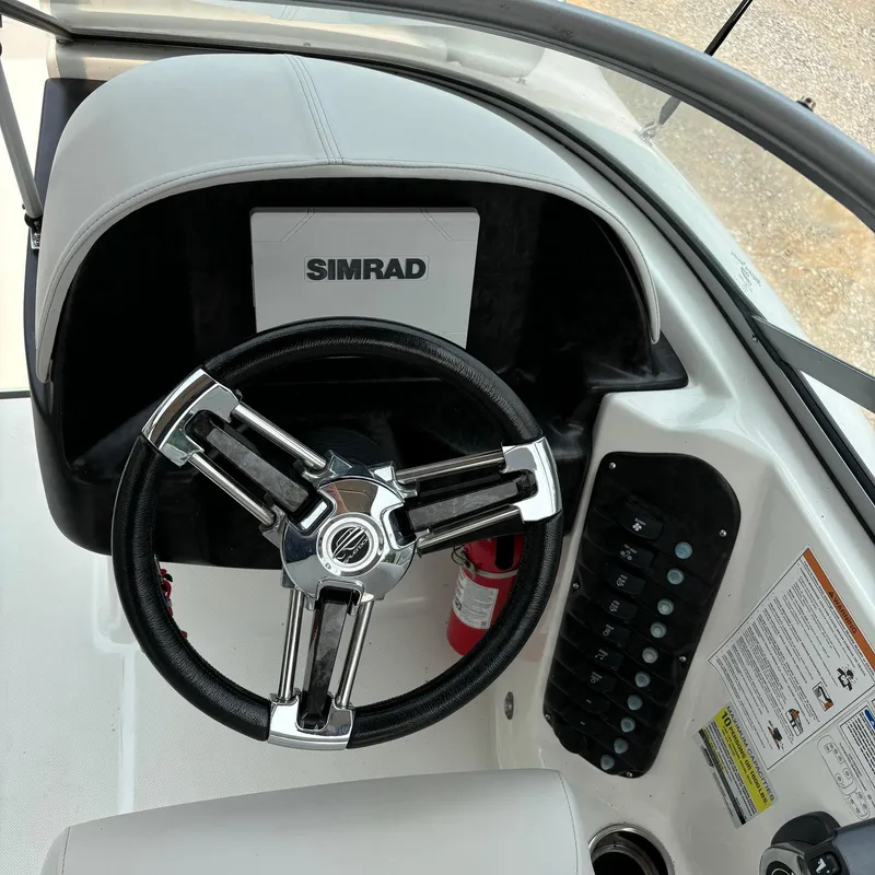 Slide: The Image of Steering wheel and control panel of 2020 Splendor Odyssey 220 boat with Simrad display. - 6