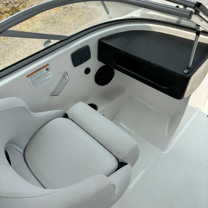 Slide: The Image of Interior of 2020 Splendor Odyssey 220 boat with white seating and dashboard. - 7