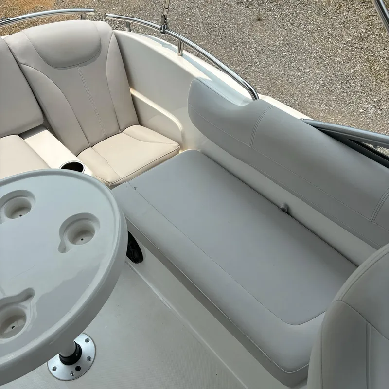 Slide: The Image of 2020 Splendor Odyssey 220 boat interior with gray seating and round table. - 8