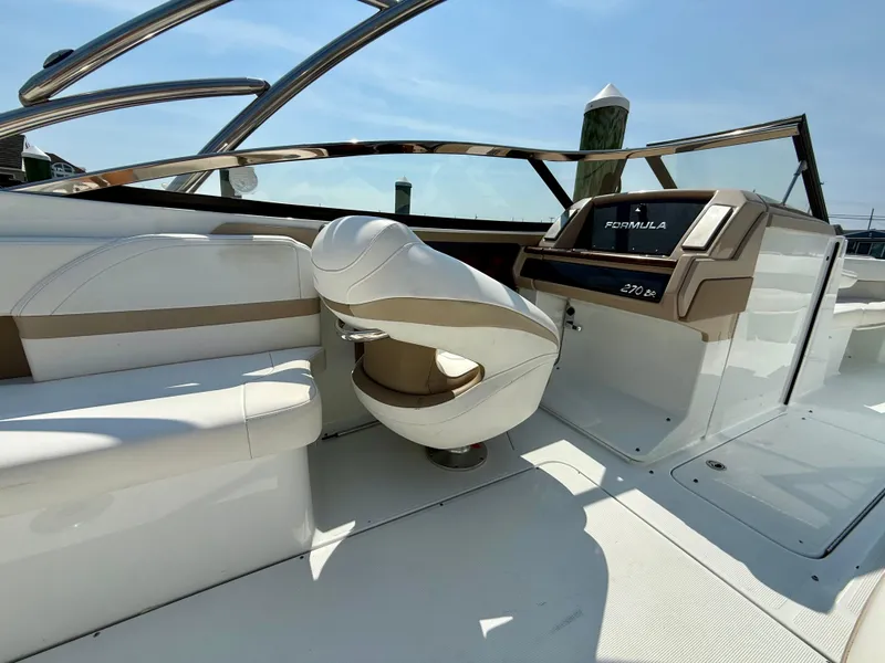 Slide: The Image of 2011 Formula 270 Bowrider interior with helm and seating, showcasing luxury design. - 2