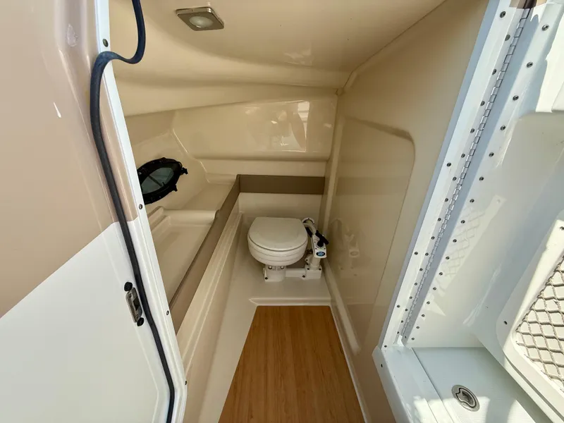 Slide: The Image of Interior of a 2011 Formula 270 Bowrider boat featuring a compact marine toilet. - 4