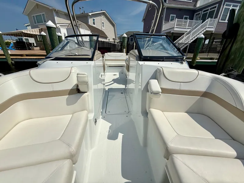 Slide: The Image of 2011 Formula 270 Bowrider with spacious seating, docked near waterfront homes. - 7
