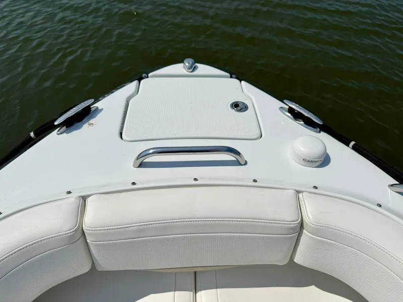 Slide: The Image of 2011 Formula 270 Bowrider boat bow with white seating and water view. - 8