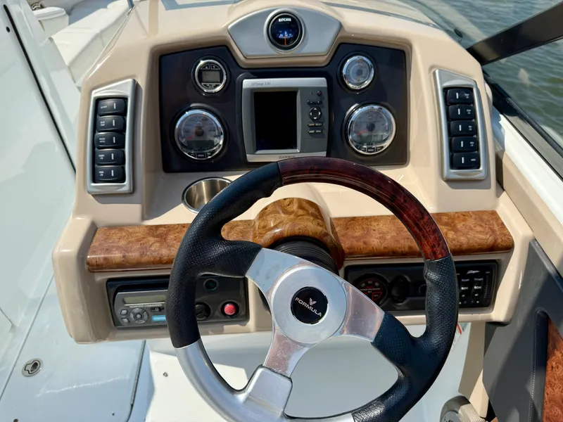 Slide: The Image of Steering console of a 2011 Formula 270 Bowrider boat with wood accents. - 9