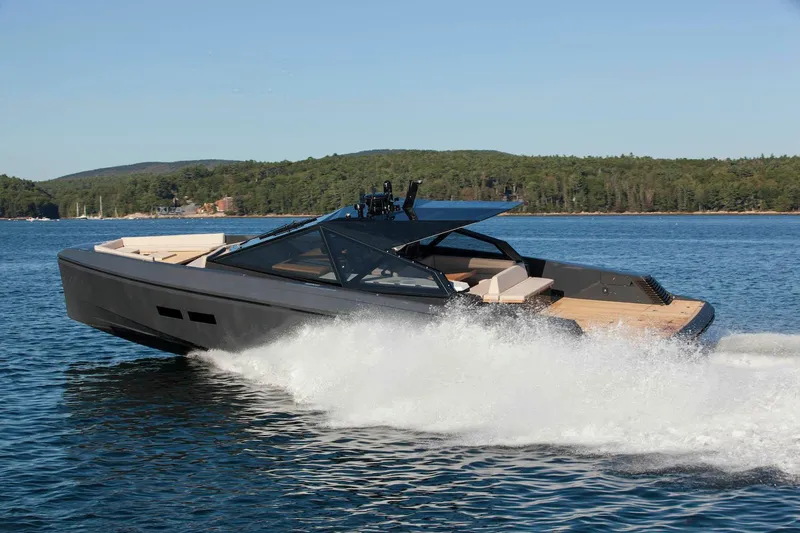 Slide: The Image of 2016 Wally Wallypower 52 yacht cruising on a serene lake with forested shoreline. - 1