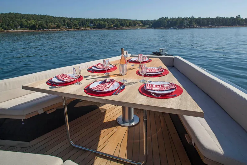 Slide: The Image of Luxury dining setup on 2016 Wally Wallypower 52 yacht, scenic water view. - 12