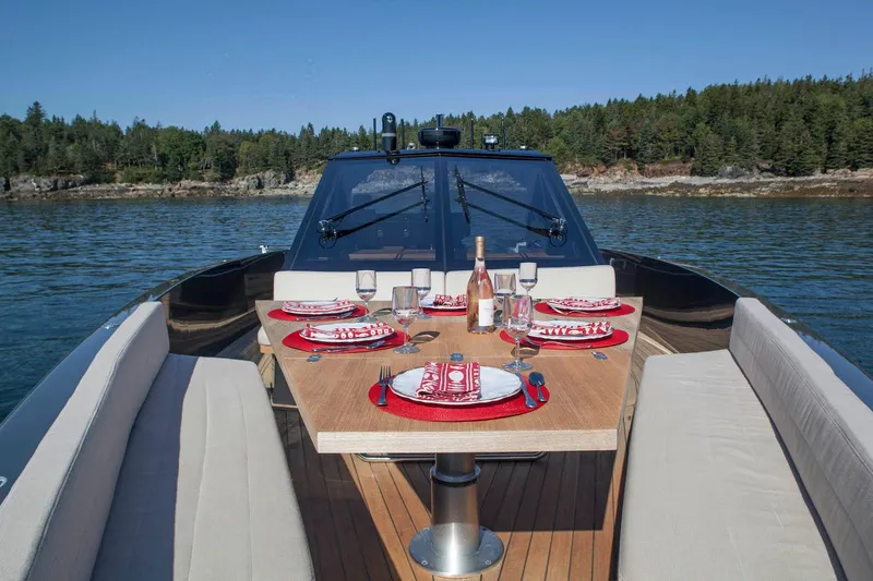 Slide: The Image of Luxurious 2016 Wally Wallypower 52 yacht with elegant dining setup on deck, surrounded by serene waters. - 13