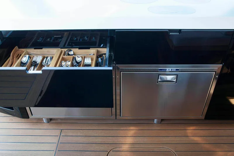 Slide: The Image of Modern kitchen on 2016 Wally Wallypower 52 yacht with sleek cabinetry and organized cutlery drawer. - 19