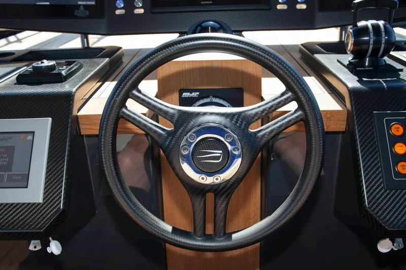 Slide: The Image of Steering wheel of 2016 Wally Wallypower 52 yacht, featuring sleek carbon fiber design. - 22