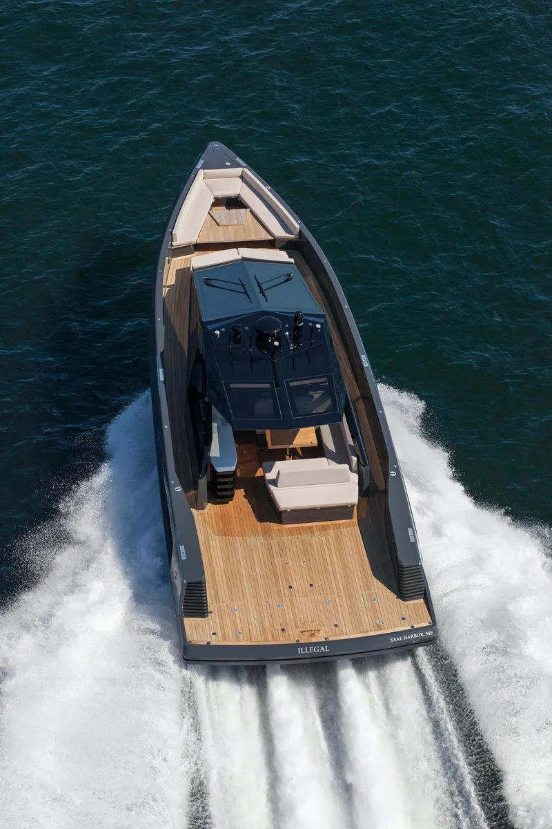 Slide: The Image of 2016 Wally Wallypower 52 yacht cruising on open water, showcasing sleek design and wooden deck. - 8