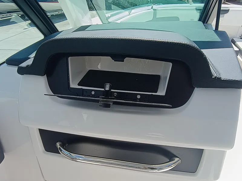 Slide: The Image of 2025 Robalo R257 Dual Console dashboard with storage compartment and handle. - 20