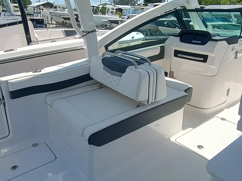 Slide: The Image of 2025 Robalo R257 Dual Console interior with white seating and modern dashboard. - 21