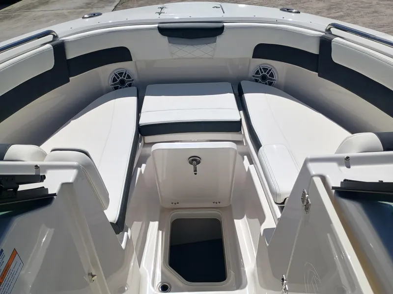 Slide: The Image of 2025 Robalo R257 Dual Console boat interior with cushioned seating and storage compartments. - 32