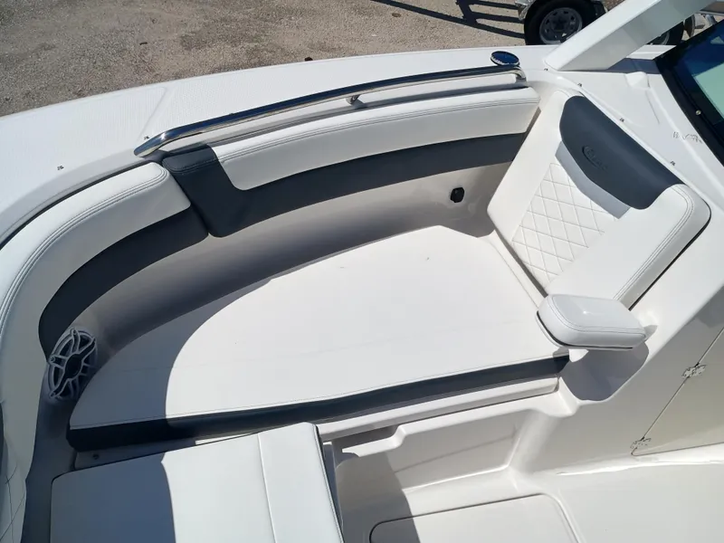 Slide: The Image of 2025 Robalo R257 Dual Console boat interior with white cushioned seating. - 34