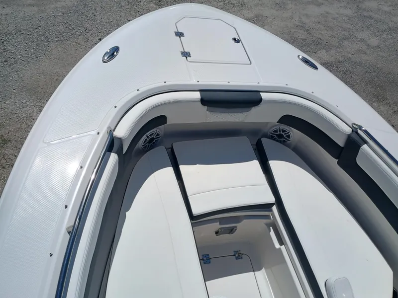 Slide: The Image of 2025 Robalo R257 Dual Console boat interior with white seating and storage compartments. - 35