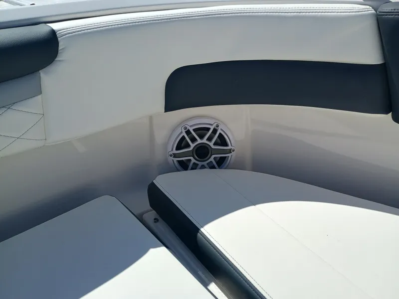 Slide: The Image of 2025 Robalo R257 Dual Console boat interior with cushioned seating and speaker. - 40