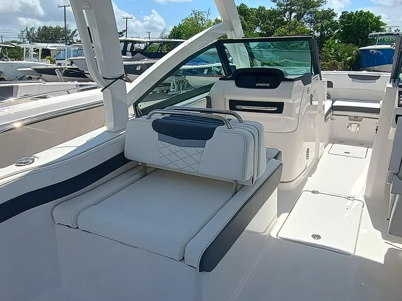 Slide: The Image of 2025 Robalo R257 Dual Console boat interior with white seating and modern dashboard. - 9