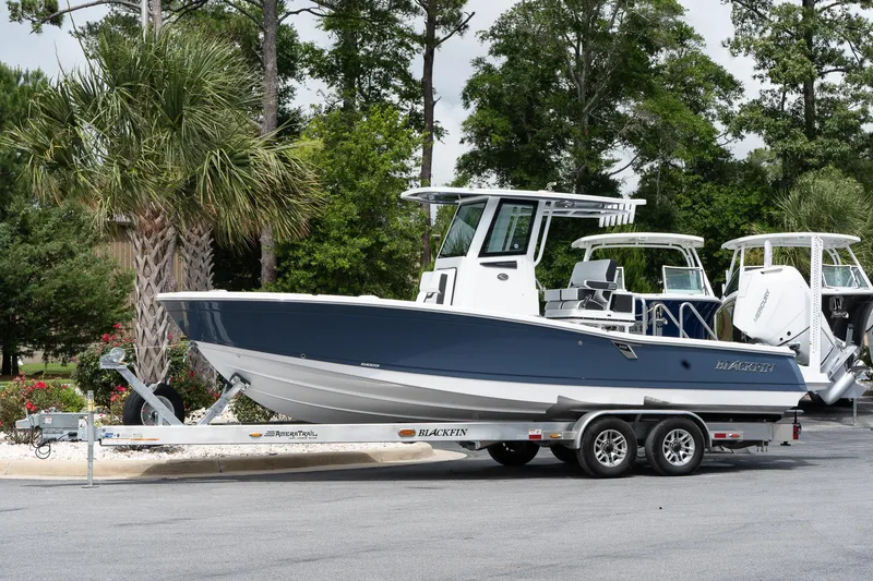 The Image of 2026 Blackfin 262 HB boat on trailer, parked outdoors with trees in background. - 1