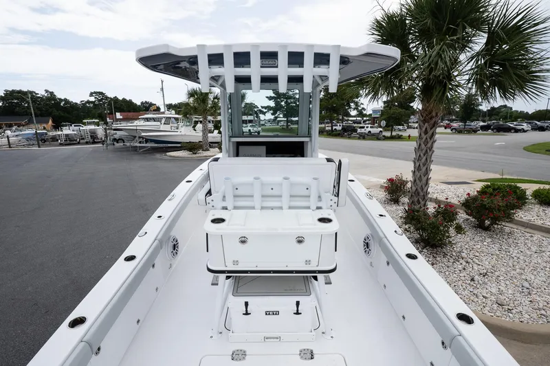 Slide: The Image of 2026 Blackfin 262 HB boat with sleek design, docked near palm trees. - 13
