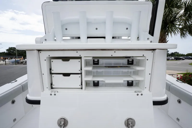 Slide: The Image of 2026 Blackfin 262 HB boat storage compartments with drawers and shelves, featuring a sleek white design. - 14