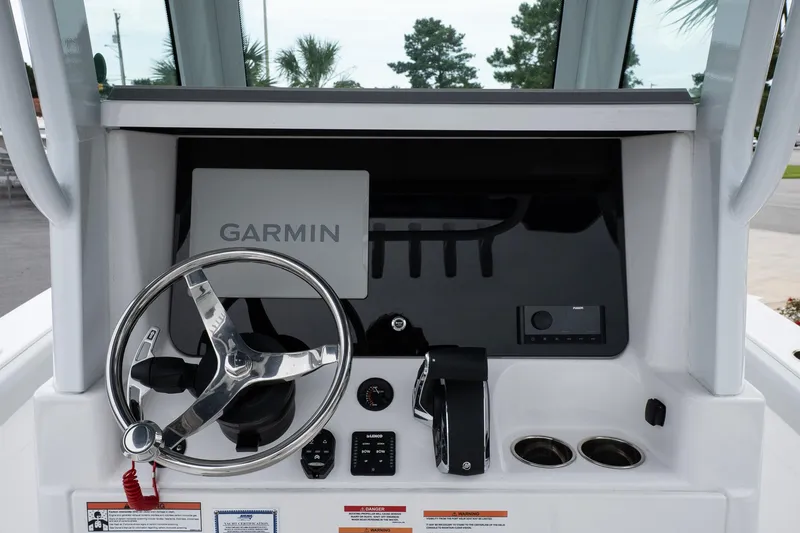 Slide: The Image of 2026 Blackfin 262 HB boat helm with Garmin navigation system and steering wheel. - 16