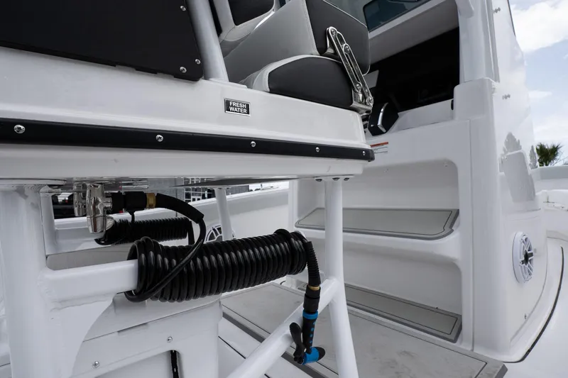 Slide: The Image of 2026 Blackfin 262 HB boat interior with seating and coiled hose. - 20