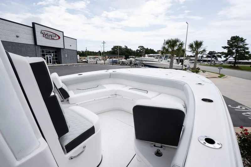 Slide: The Image of 2026 Blackfin 262 HB boat with spacious seating, docked near a marina. - 22