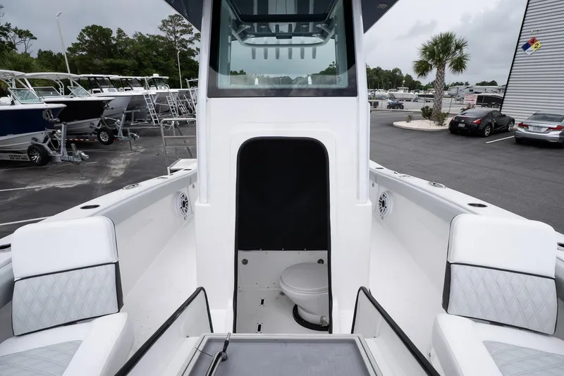 Slide: The Image of 2026 Blackfin 262 HB boat interior with seating and a compact toilet area. - 24