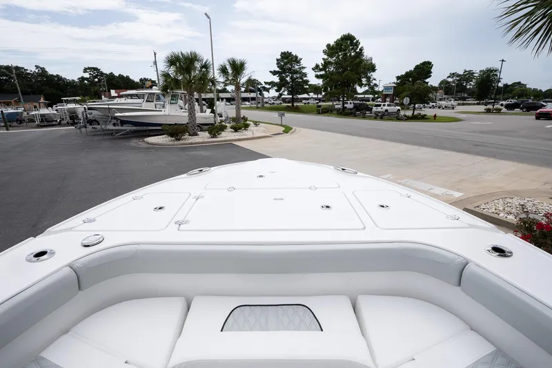 Slide: The Image of 2026 Blackfin 262 HB boat bow view in a marina setting. - 25