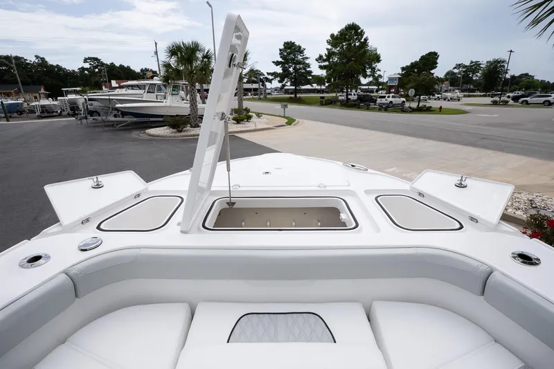 Slide: The Image of 2026 Blackfin 262 HB boat with open storage compartment, docked in a marina. - 26