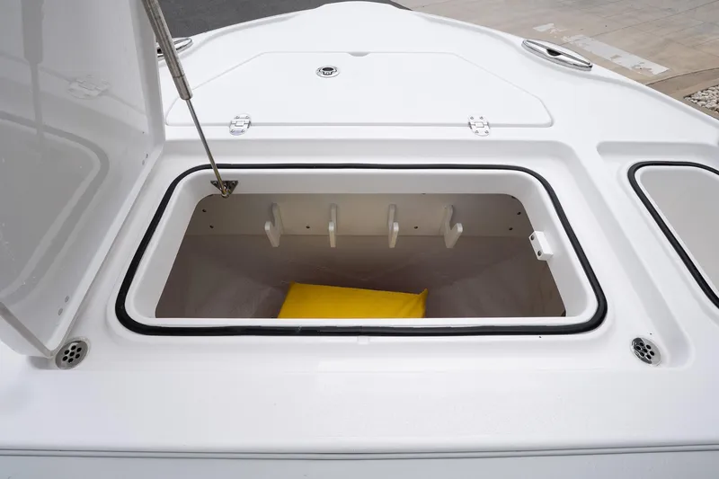 Slide: The Image of Open storage compartment on 2026 Blackfin 262 HB boat, featuring a yellow cushion inside. - 28
