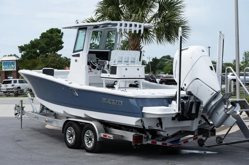 Slide: The Image of 2026 Blackfin 262 HB boat on trailer, parked outdoors near palm tree. - 4