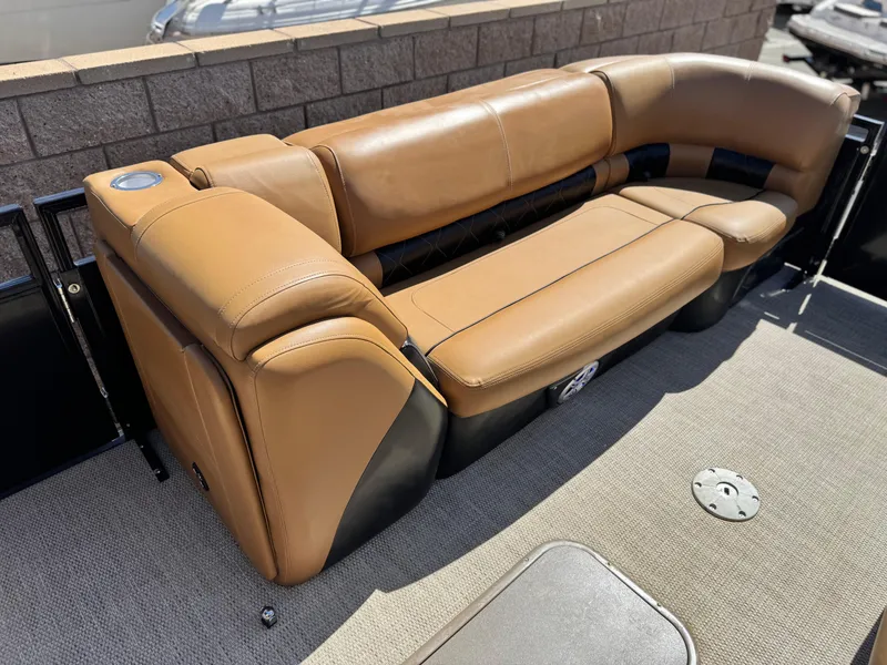 Slide: The Image of 2021 Regency 230 LE3 boat with tan leather seating and cup holder. - 12