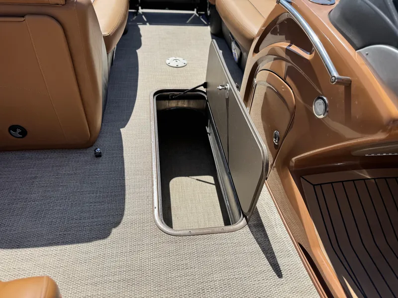 Slide: The Image of 2021 Regency 230 LE3 boat interior with open storage compartment. - 14