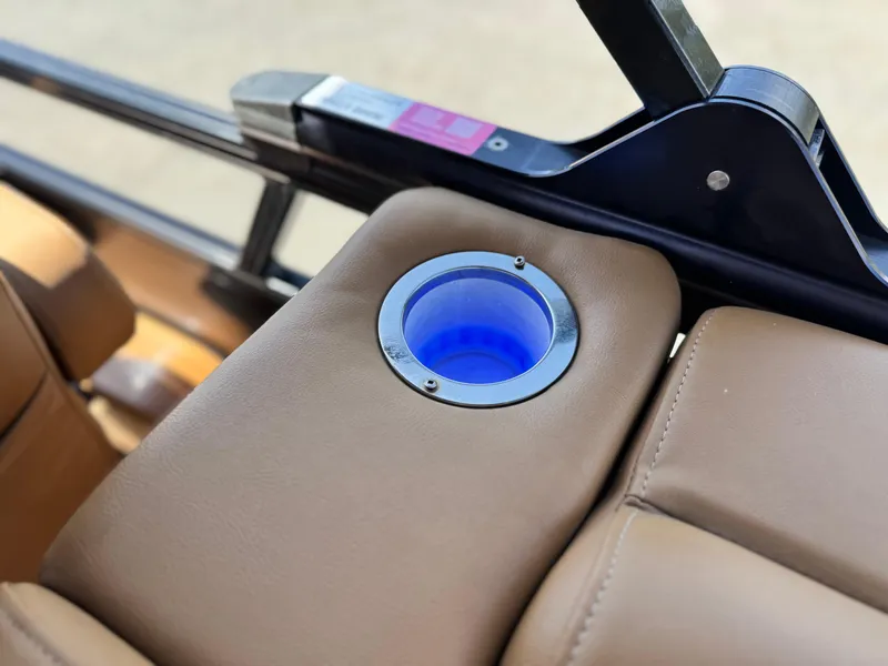 Slide: The Image of Cup holder with blue light on 2021 Regency 230 LE3 boat's tan leather seat. - 20