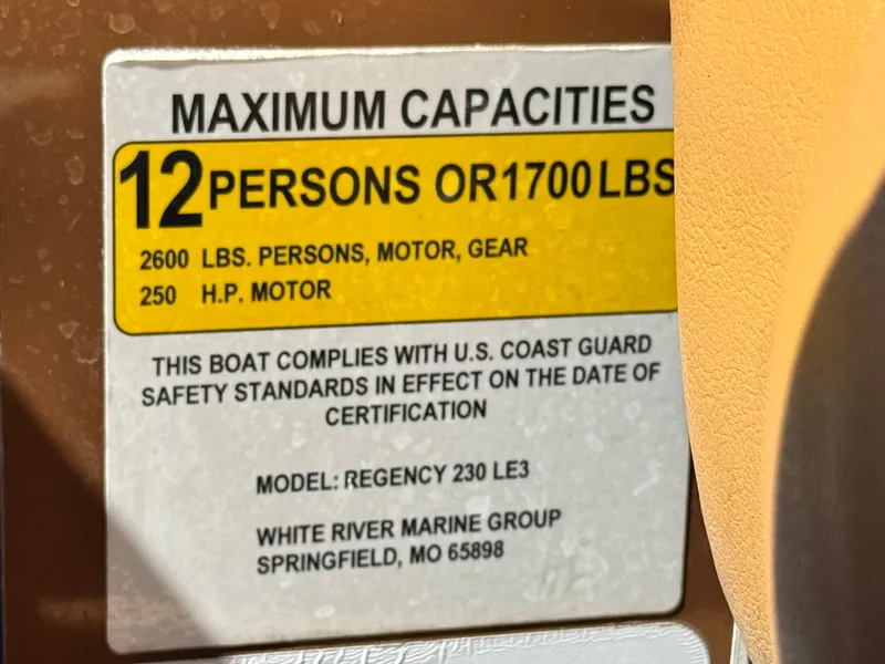 Slide: The Image of Maximum capacity label for 2021 Regency 230 LE3 boat, 12 persons or 1700 lbs. - 27