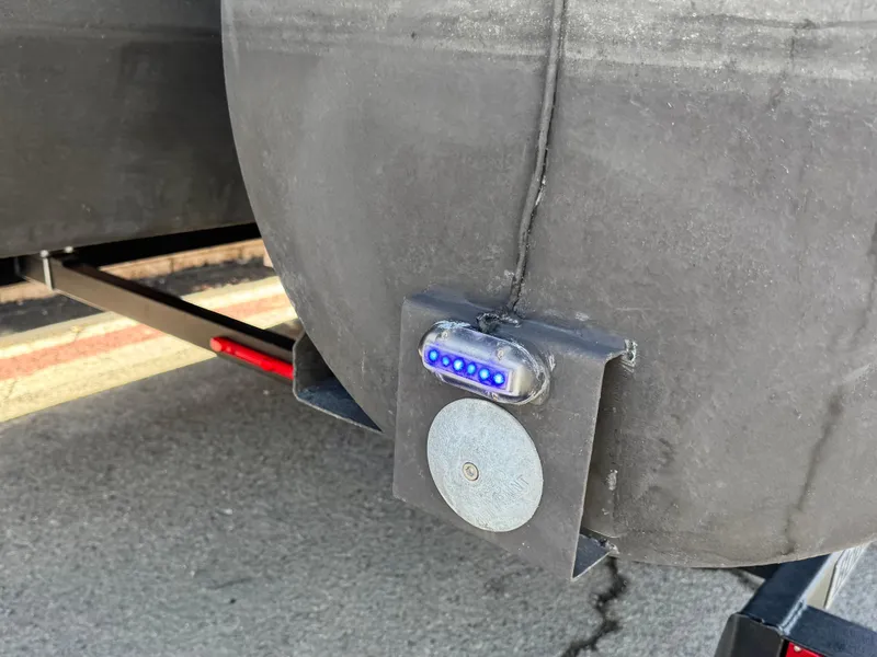 Slide: The Image of 2021 Regency 230 LE3 pontoon boat with blue LED light and metal fixture. - 7