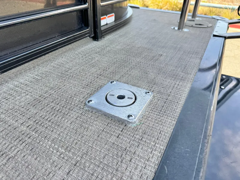 Slide: The Image of 2021 Regency 230 LE3 boat deck with metal fixture, textured surface. - 9