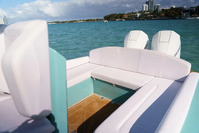 Slide: The Image of 2025 Novielli Veloche boat interior with white seating, turquoise accents, and twin outboard motors. - 10