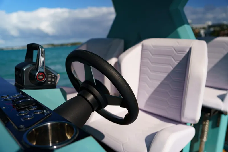 Slide: The Image of Steering wheel and controls of 2025 Novielli Veloche boat, featuring modern design and comfortable seating. - 15