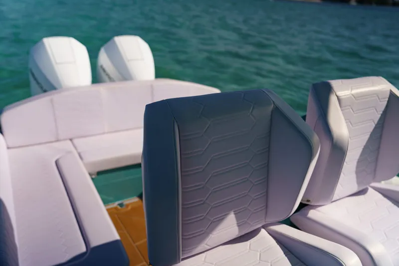 Slide: The Image of 2025 Novielli Veloche boat interior with modern seating and dual engines on a serene water backdrop. - 18