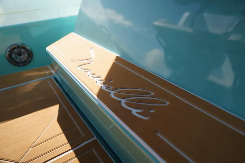 Slide: The Image of Novielli Veloche 2025 boat interior with elegant wood and turquoise design. - 5